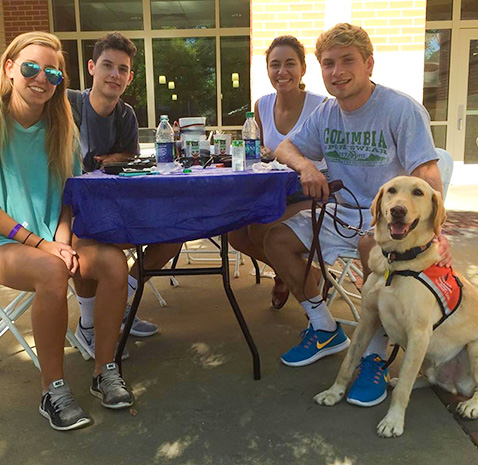 Dogtor Moose with students on campus